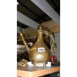 A 19th century middle eastern brass coffee pot