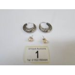 A pair of silver hoop earrings and a pair of silver stud earrings