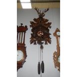 A large carved wood cuckoo clock