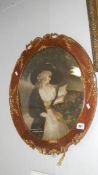 An oval ornate framed portrait