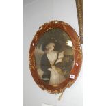 An oval ornate framed portrait