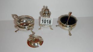 A silver cruet set with 2 silver spoons (Lid on mustard pot has hinge pin missing)