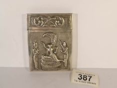 An unmarked white metal card case,