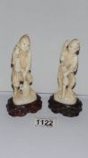 A pair of old signed ivory figures