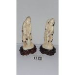 A pair of old signed ivory figures