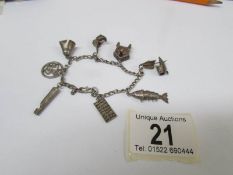 An interesting old silver charm bracelet with 8 charms