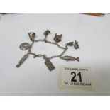 An interesting old silver charm bracelet with 8 charms