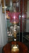 A Victorian brass column oil lamp in working order