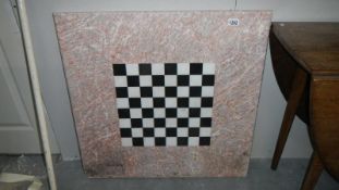 A very heavy chequered marble table top