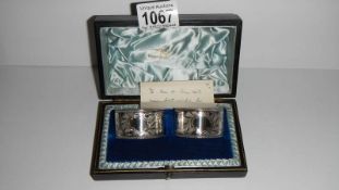 A pair of boxed silver napkin rings