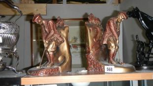 A pair of pottery golfer bookends,