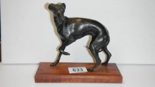 A bronze whippet on wood base