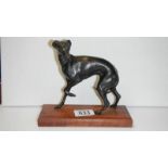 A bronze whippet on wood base