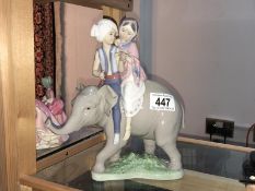 A Lladro elephant with figures on top
