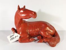 A sculptured / carved oriental figure of a horse