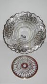 A fine sterling silver overlaid plate and a hall marked silver and glass stand