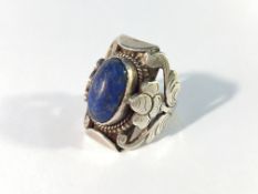 An unusual vintage oval lapis lazuli stone ring with floral shoulders,