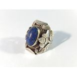 An unusual vintage oval lapis lazuli stone ring with floral shoulders,