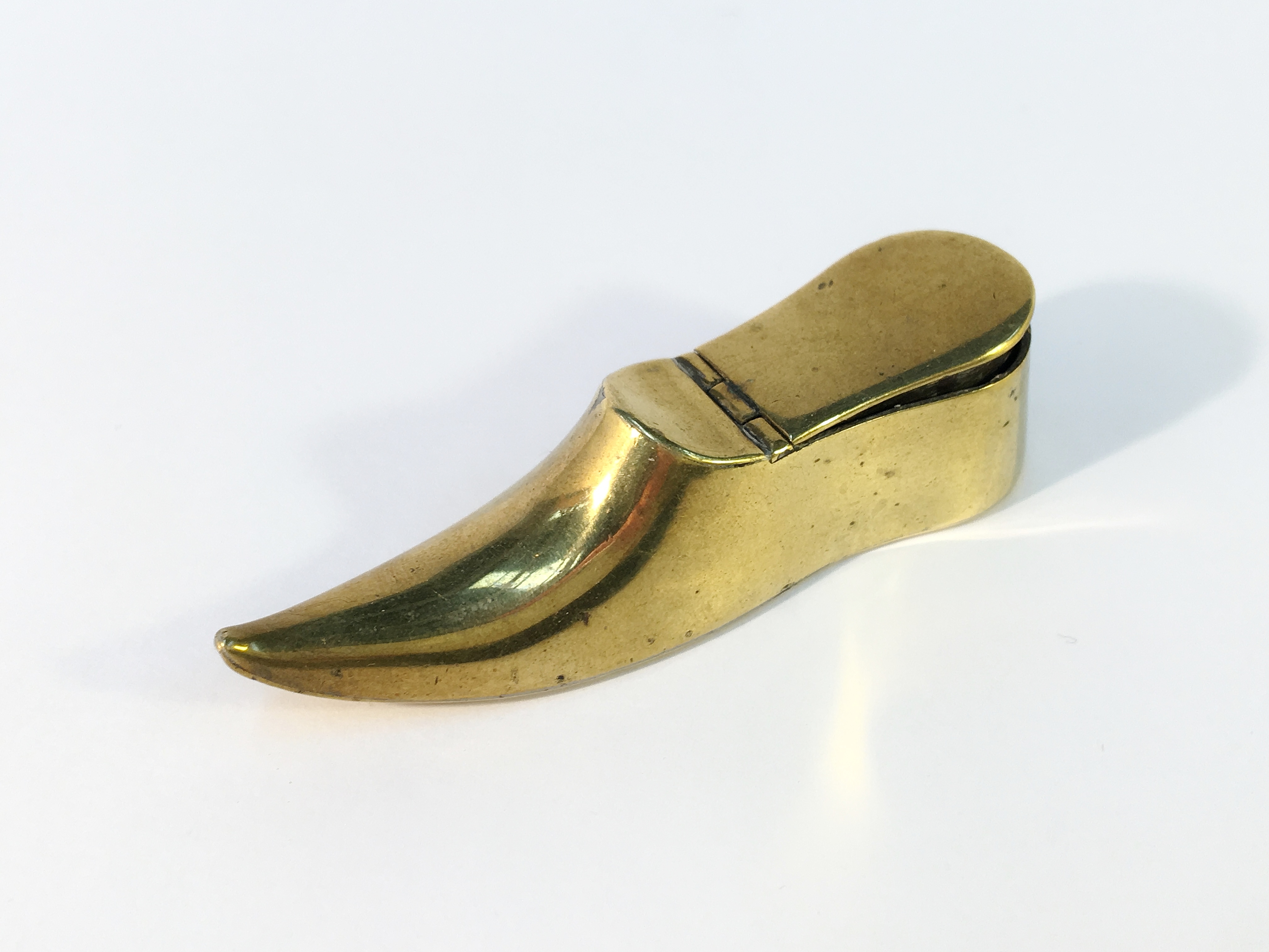 A Victorian brass shoe snuff box