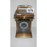 A large brass carriage clock with enamel face