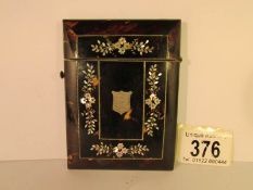 A 19th century tortoise shell card case inlaid with mother of pearl and monogrammed,