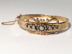 An Edwardian rose gold bangle set old cut diamonds