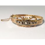 An Edwardian rose gold bangle set old cut diamonds