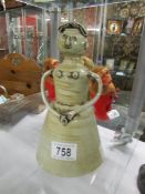 An unusual Naive art pottery figure initialled R.E.