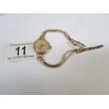 A ladies Accurist gold watch and bracelet,