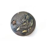 A Samurai warrior's bronze button decorated with a warrior and with gold highlights