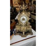 A tall Victorian brass mantel clock