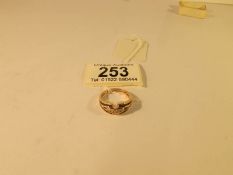 An unusual design diamond and sapphire ring in 9ct gold