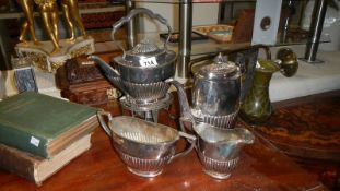 An old 4 piece silver plate tea set with kettle on stand