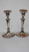 A pair of silver candlesticks, hall marked Sheffield,