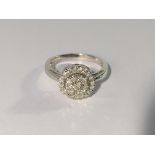 A circular white gold half carat diamond ring,