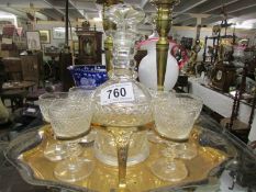 A Victorian decanter and 6 glasses of gilded stand
