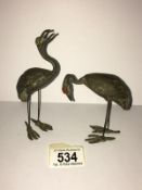 2 bronze herons