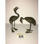 2 bronze herons