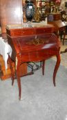 An ladies writing desk with brass inlay