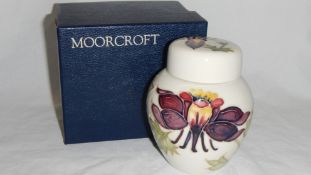 A Moorcroft 'Columbine Aquilegia' on ivory ground ginger jar designed by Walter Moorcroft (boxed)