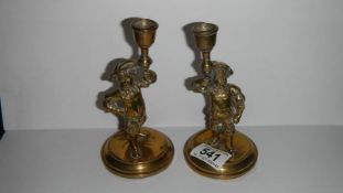 A pair of brass figural candlesticks