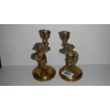 A pair of brass figural candlesticks