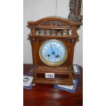 An oak bracket clock with enamel dial