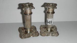 A pair of silver candlesticks with sconces,