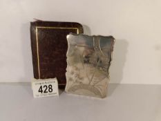 A cased unmarked Victorian white metal card case engraved with birds and foliage,