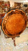 An English walnut marquetry centre table on tripod base