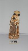 A 19th century ivory figure of a fisherman with net