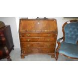 A mahogany bureau with brass drop handles