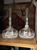 A pair of fine Mary Gregory glass decanters decorated on both sides with boy and girl figures with