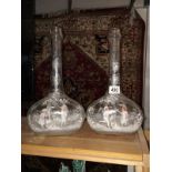 A pair of fine Mary Gregory glass decanters decorated on both sides with boy and girl figures with